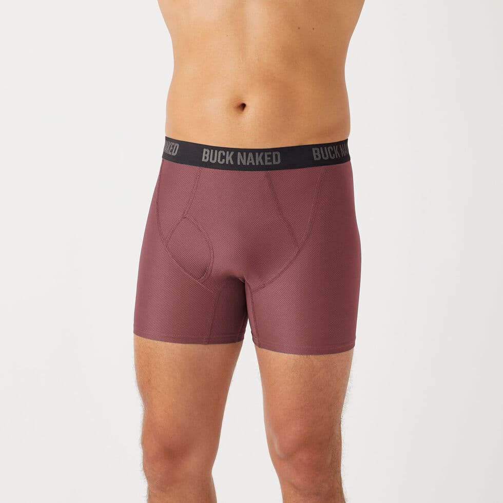 Model wearing burgundy Duluth Buck Naked Performance boxer briefs