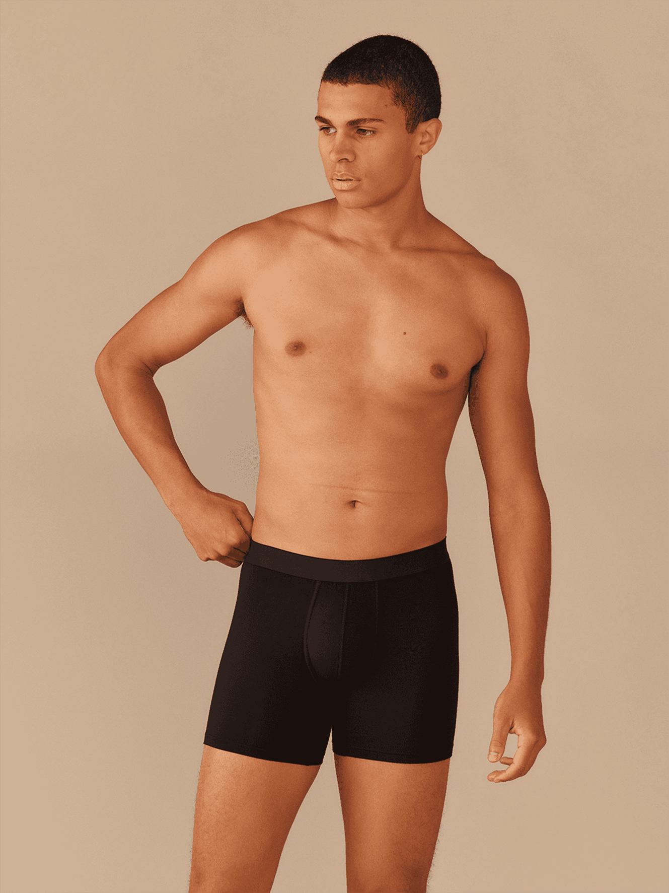 Model wearing black MeUndies UltraModal boxer briefs