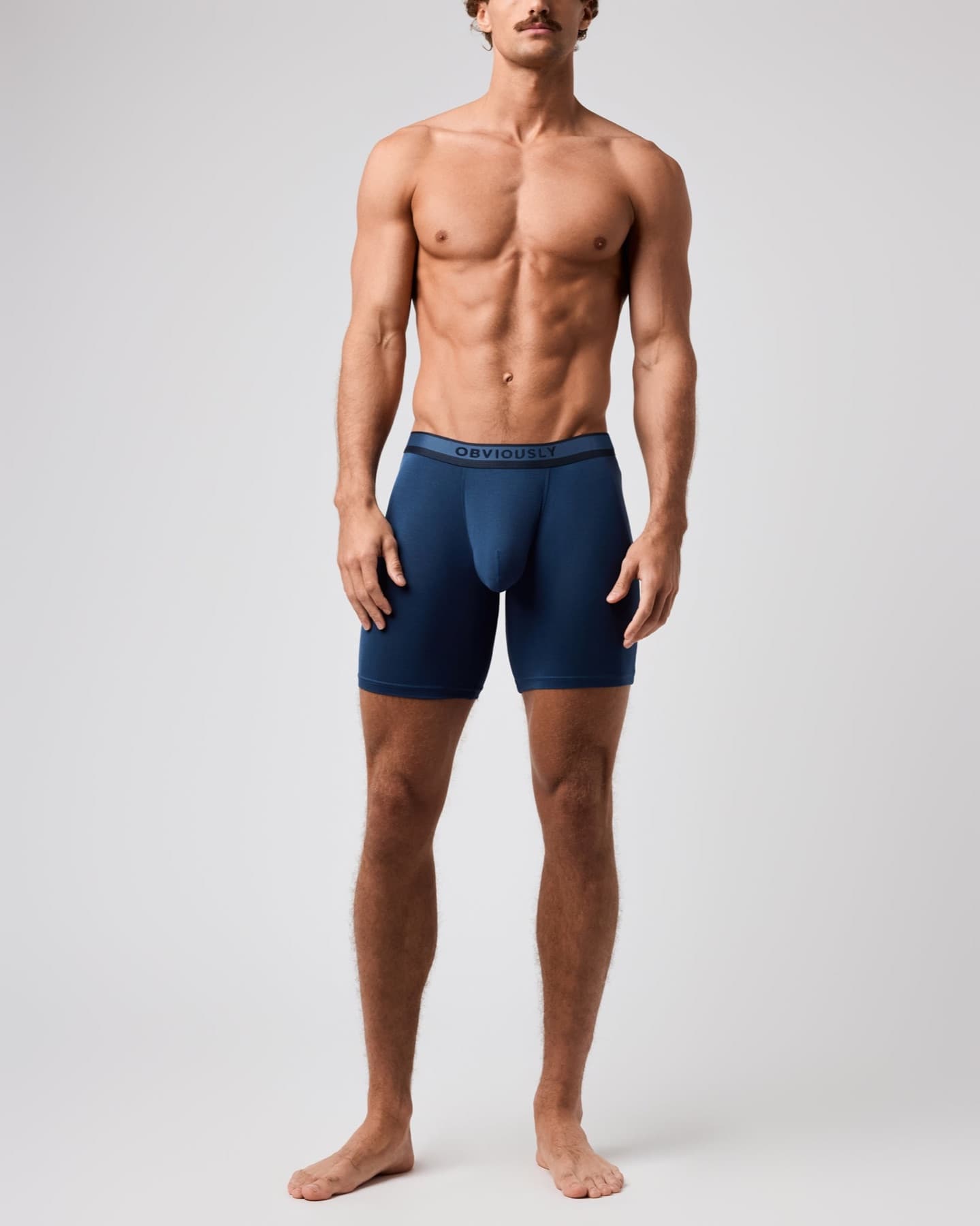 Model wearing blue Obviously PrimeMan boxer briefs