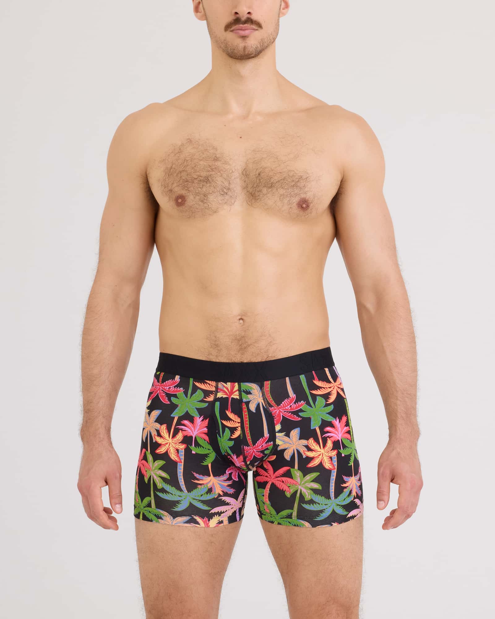 Model wearing SAXX DropTemp Cooling Cotton boxer briefs in Mixed Palms