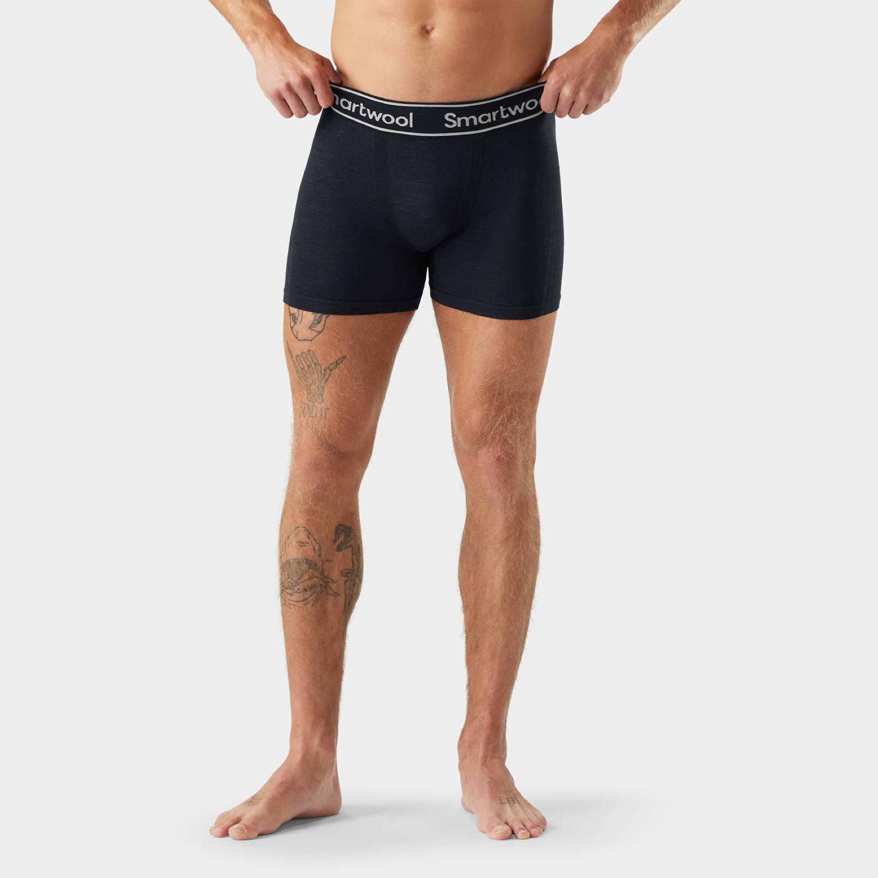 Model wearing black Smartwool Intraknit boxer briefs