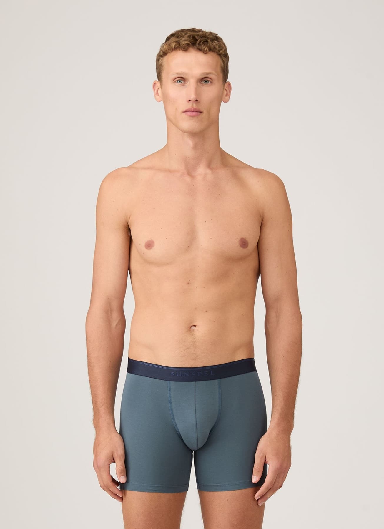 Model wearing blue Sunspel stretch-cotton boxer briefs
