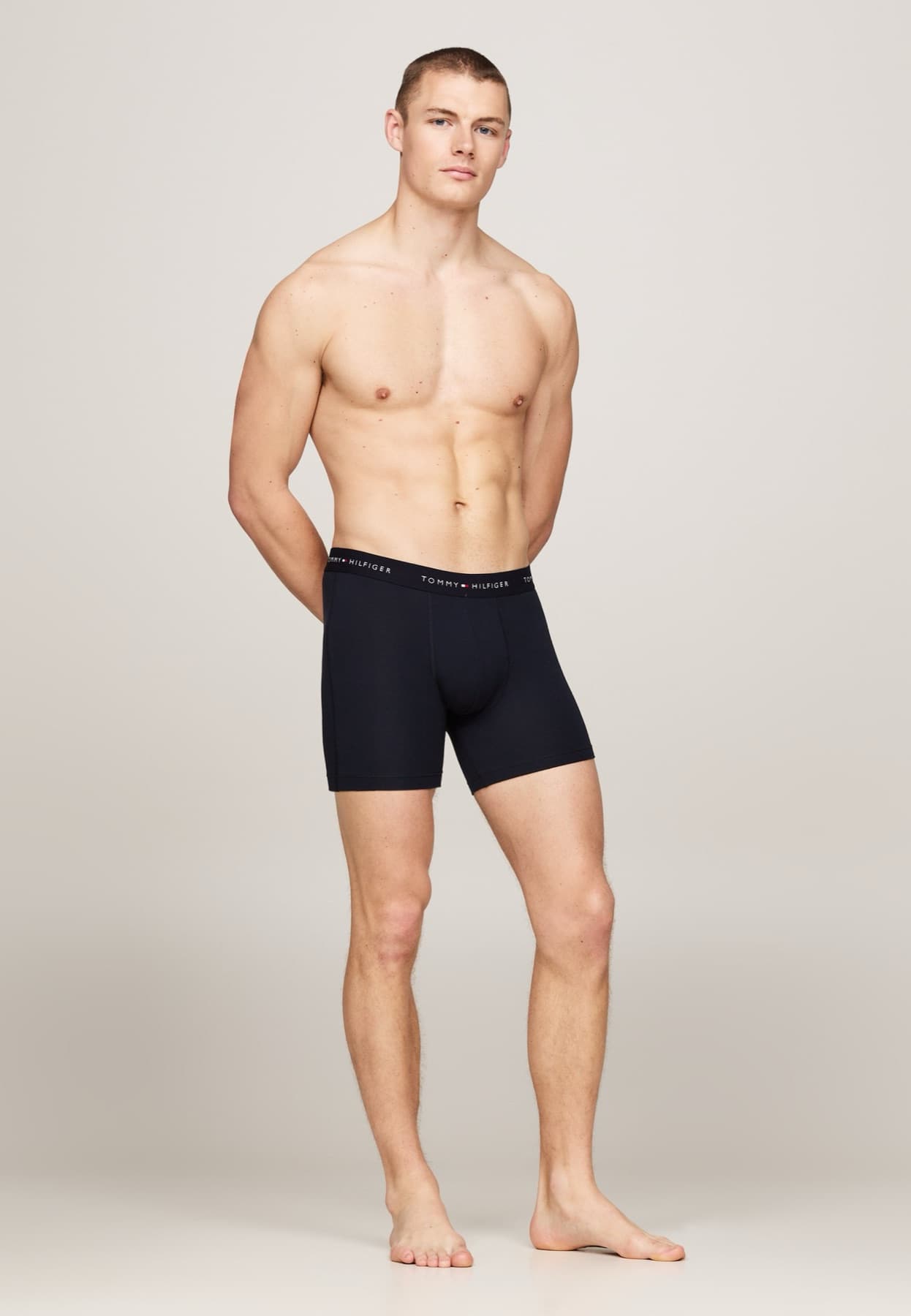 Model wearing navy Tommy Hilfiger boxer briefs