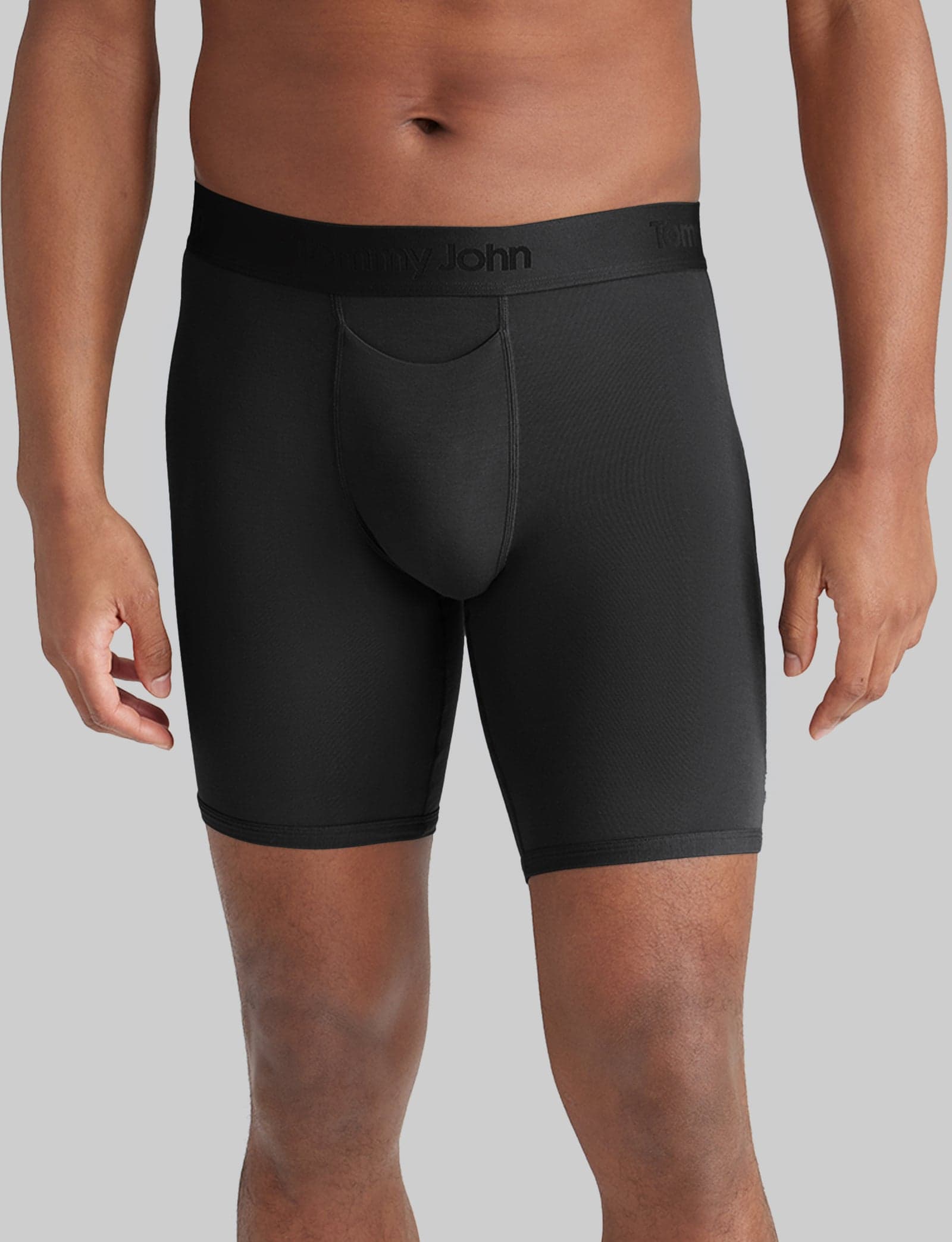 Model wearing black Tommy John Second Skin 8-inch boxer briefs
