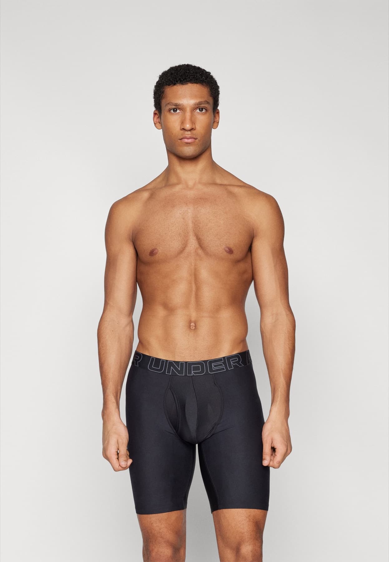 Model wearing black Under Armour Performance Tech boxer briefs